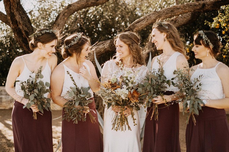 Bride standing with bridesmaids outside