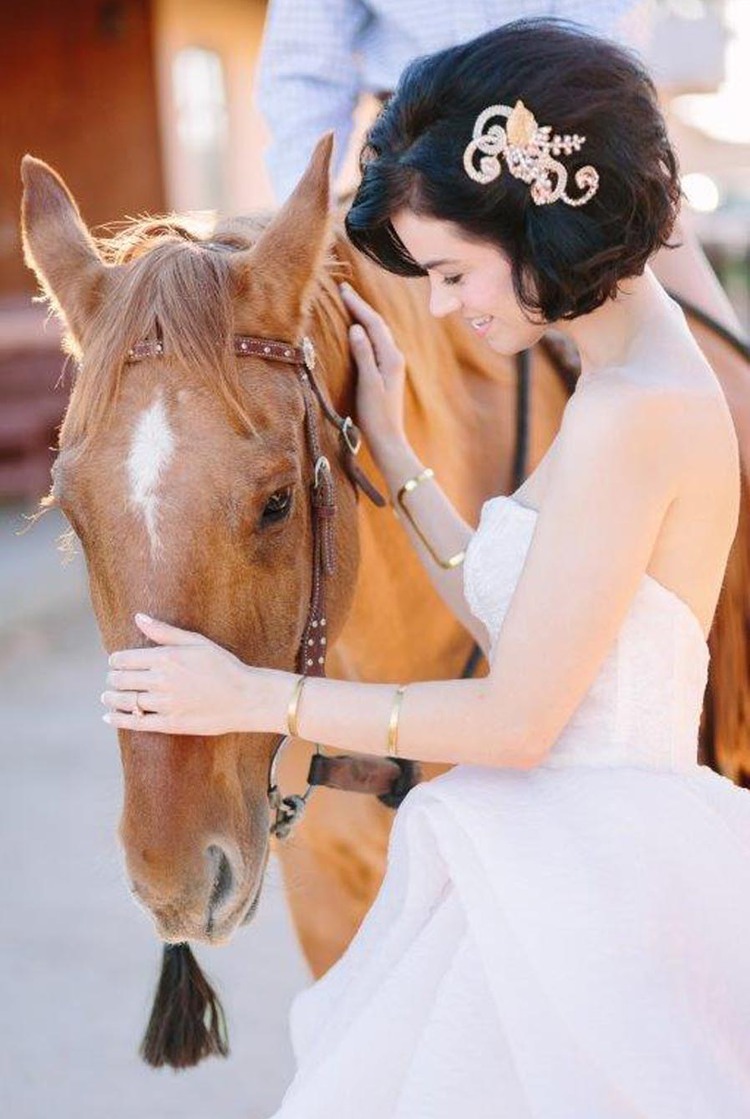 Bride standing with brown horse