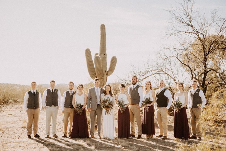 Group of people standing in front of large cactus