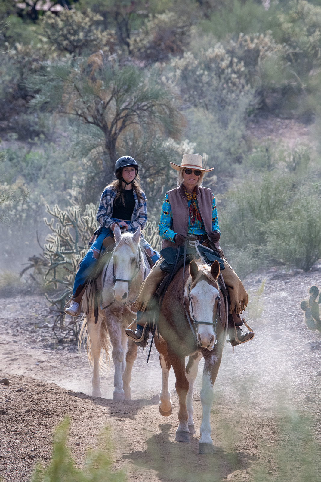 Mother and daughter riding on horses